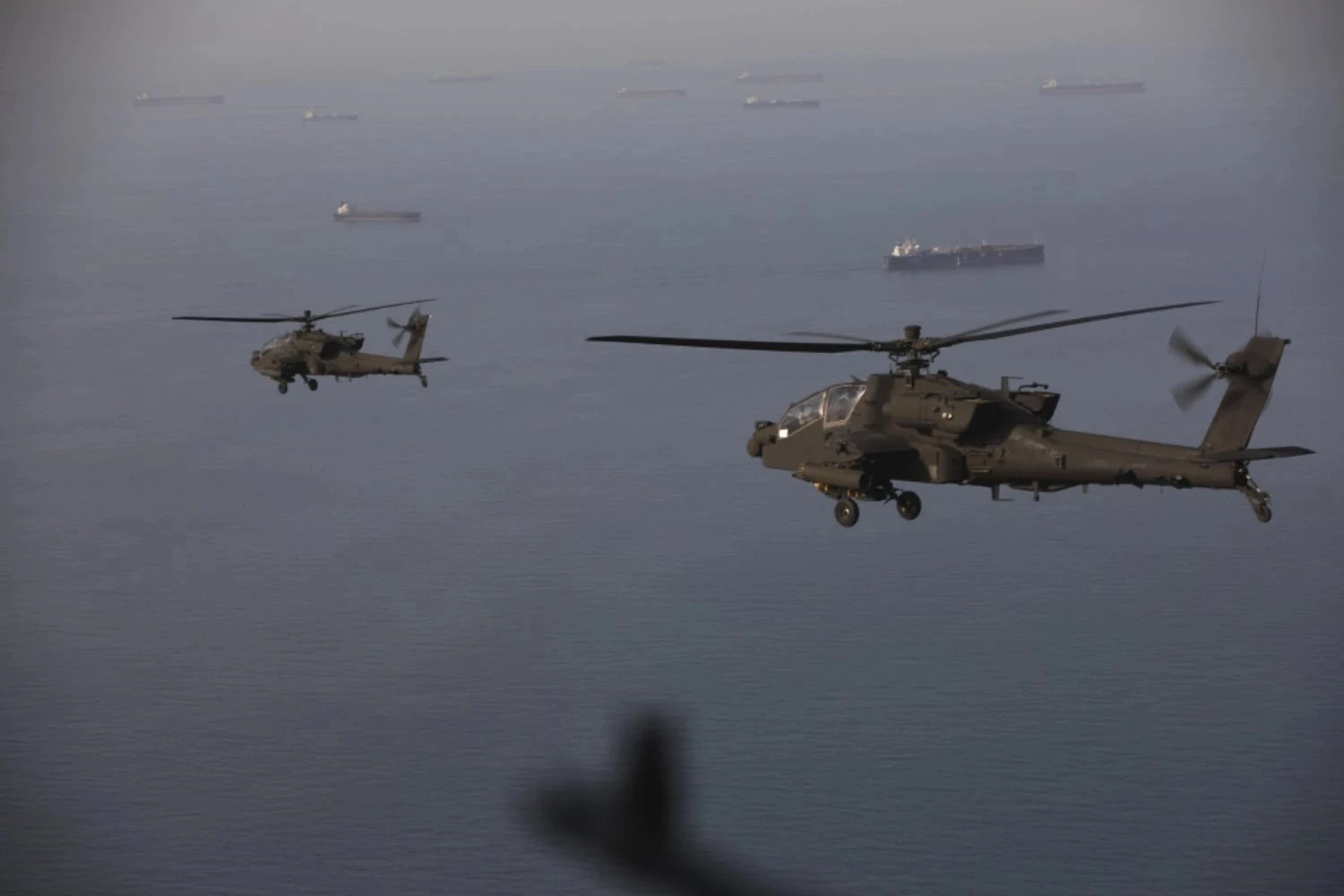 US Army Apache helicopters patrol ships in the Strait of Hormuz (CENTCOM)