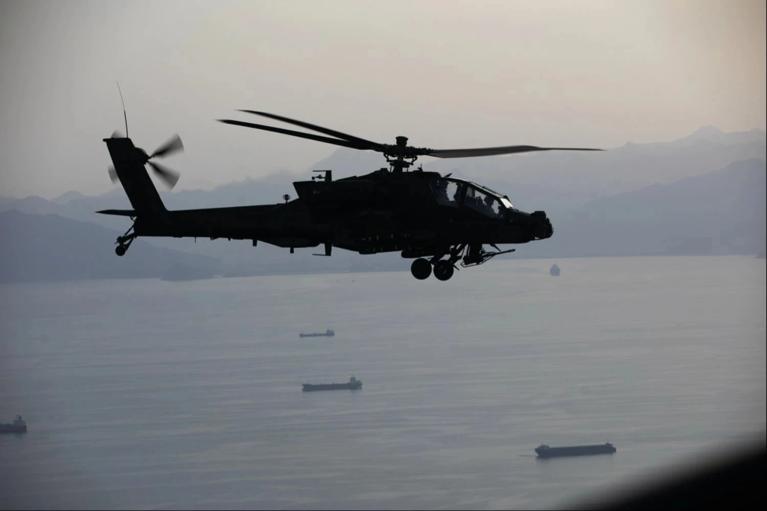 US Army Apache helicopters patrol ships in the Strait of Hormuz (CENTCOM)