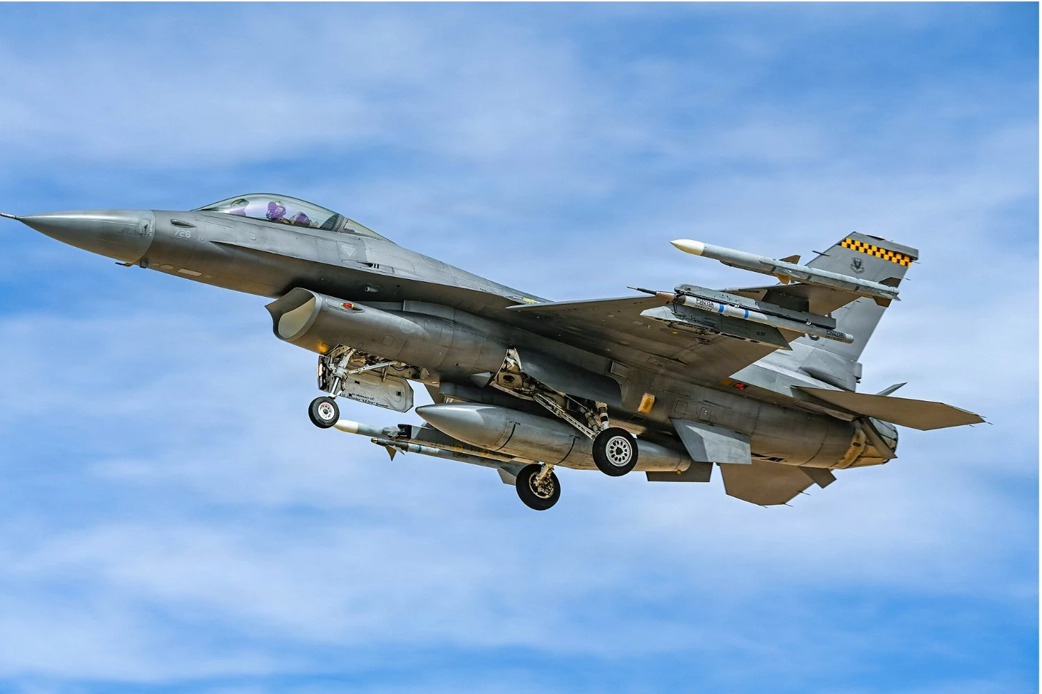 A U.S. Air Force F-16 Fighting Falcon aircraft assigned to 64th Aggressor Squadron prepares to land at Nellis Air Force Base, Nevada | AIRMAN ANNIKA SCHERMERHORN
