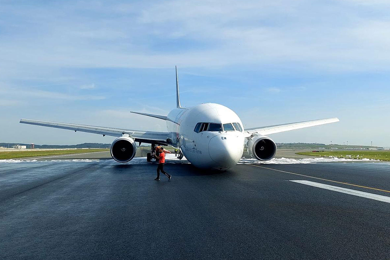 The FedEx Boeing 767F with the front landing gear retracted on the runway at Istanbul Airport